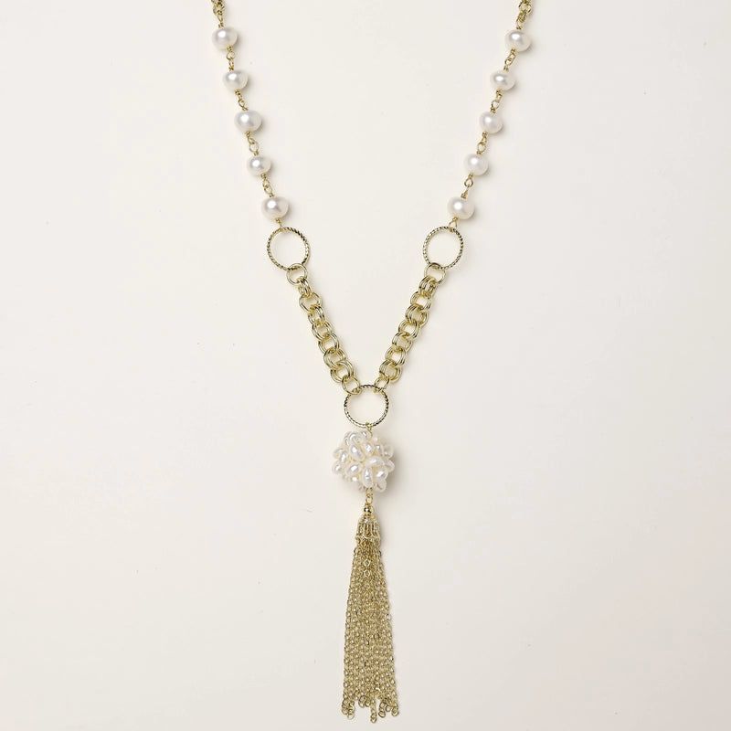 Long gold-plated necklace with freshwater pearls, chunky chain links, and flowing tassel pendant