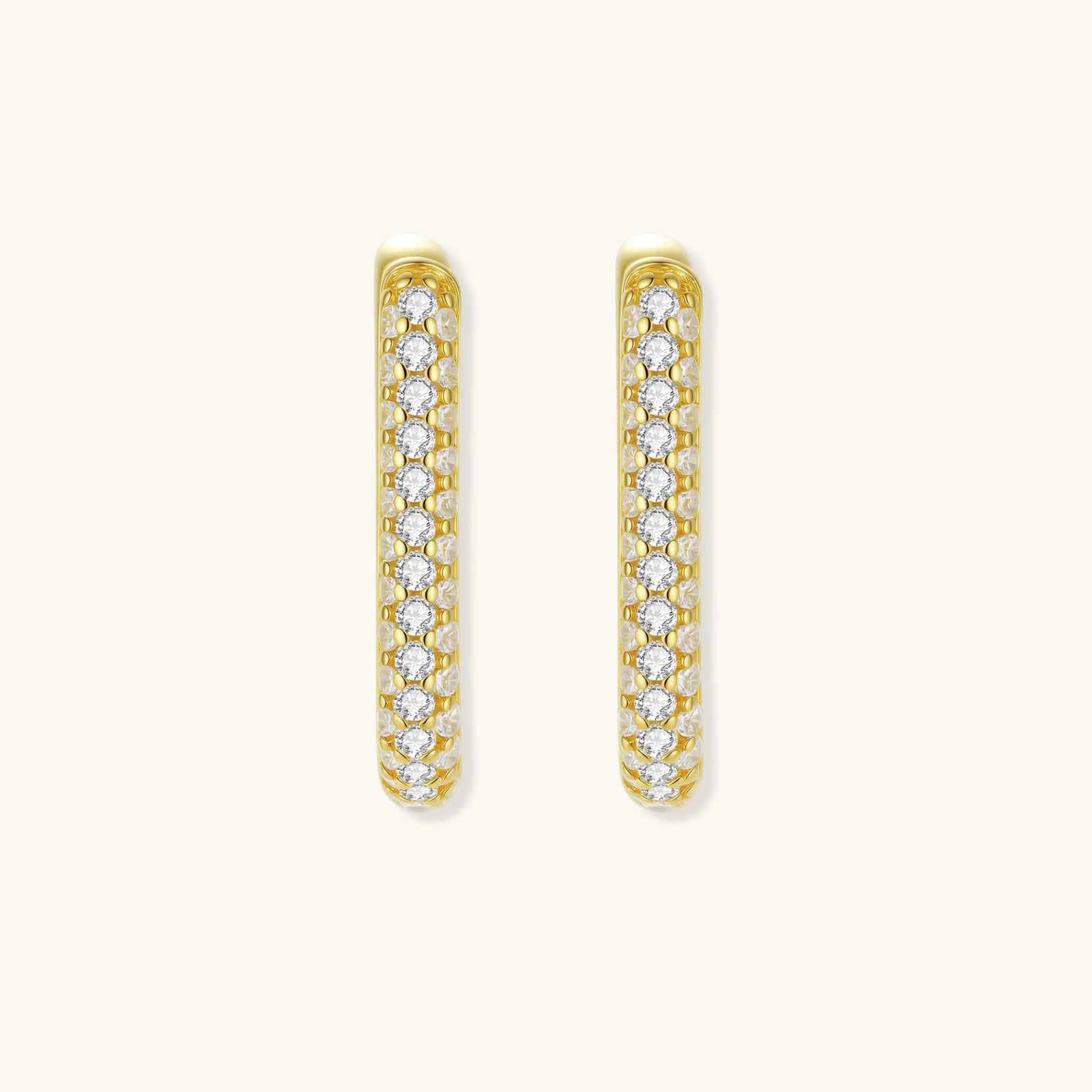 Close-up of small sterling silver huggie hoops completely covered in sparkling clear crystals with hinged closure