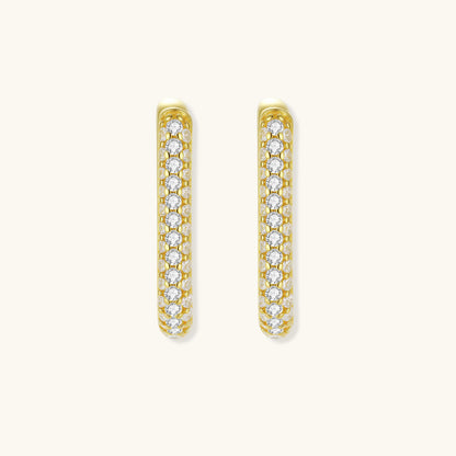 Close-up of small sterling silver huggie hoops completely covered in sparkling clear crystals with hinged closure