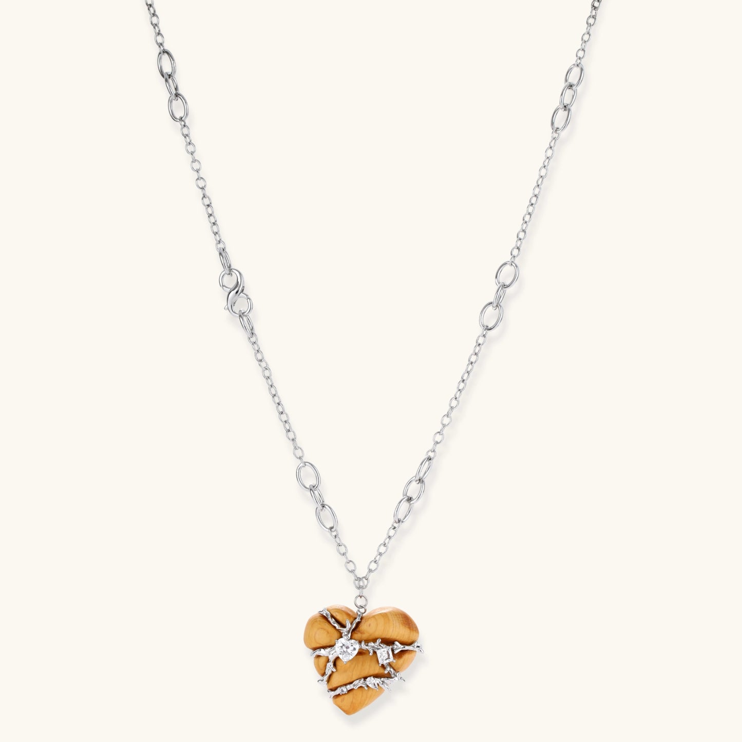 Adjustable brass chain necklace with natural wood heart pendant featuring wire wrapping and zirconia crystal accents