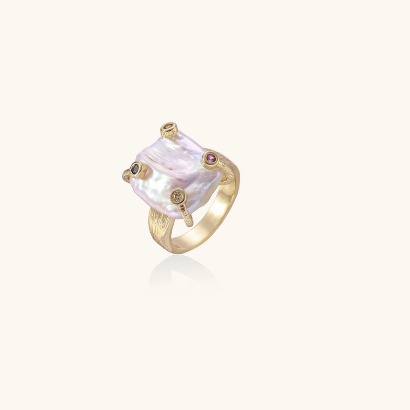 Gold ring with large iridescent baroque pearl and four colored gemstones on textured band